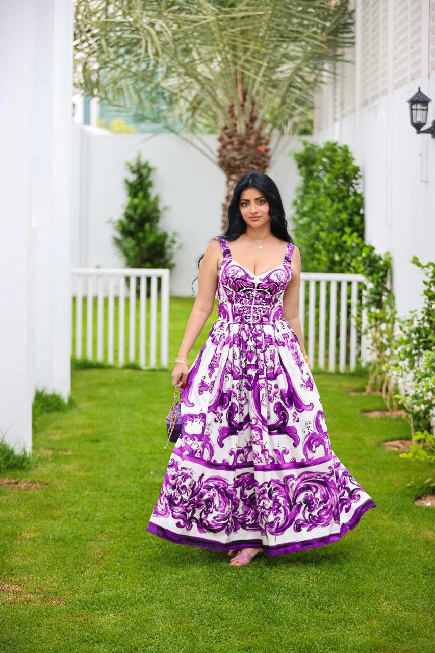 Zara Shafiq Khan photographed outdoors in a purple and white patterned dress